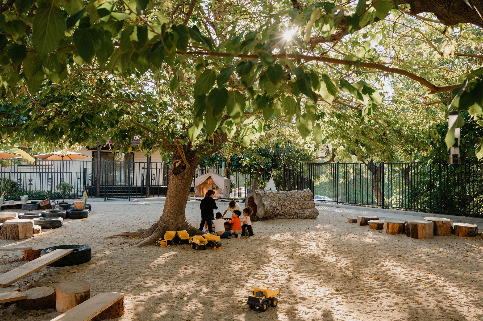 Children exploring together in Orchard Atelier's outdoor learning area