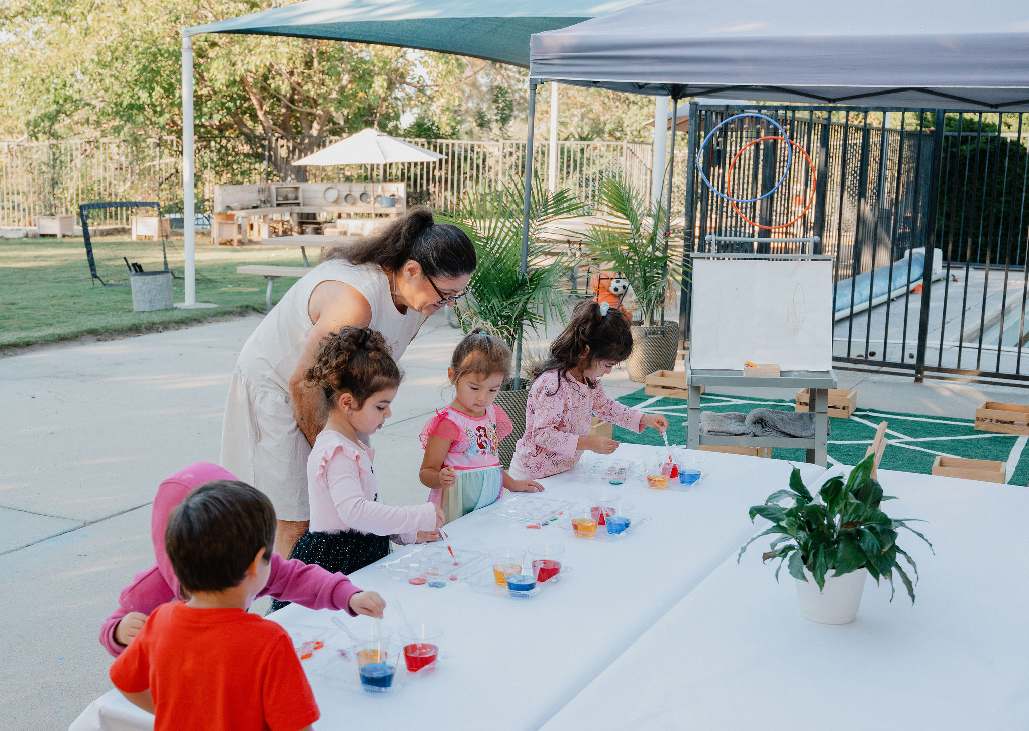Children exploring a hands-on color activity with an educator at Orchard Atelier